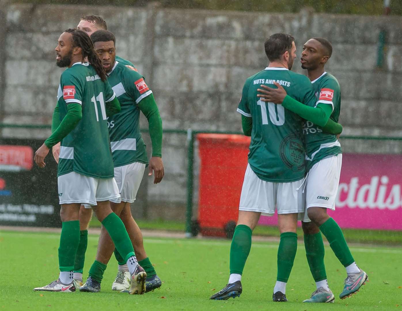 Ashford celebrate Vance Bola's goal. The goalscorer is next to skipper Bradley Simms (No.11). Picture: Ian Scammell