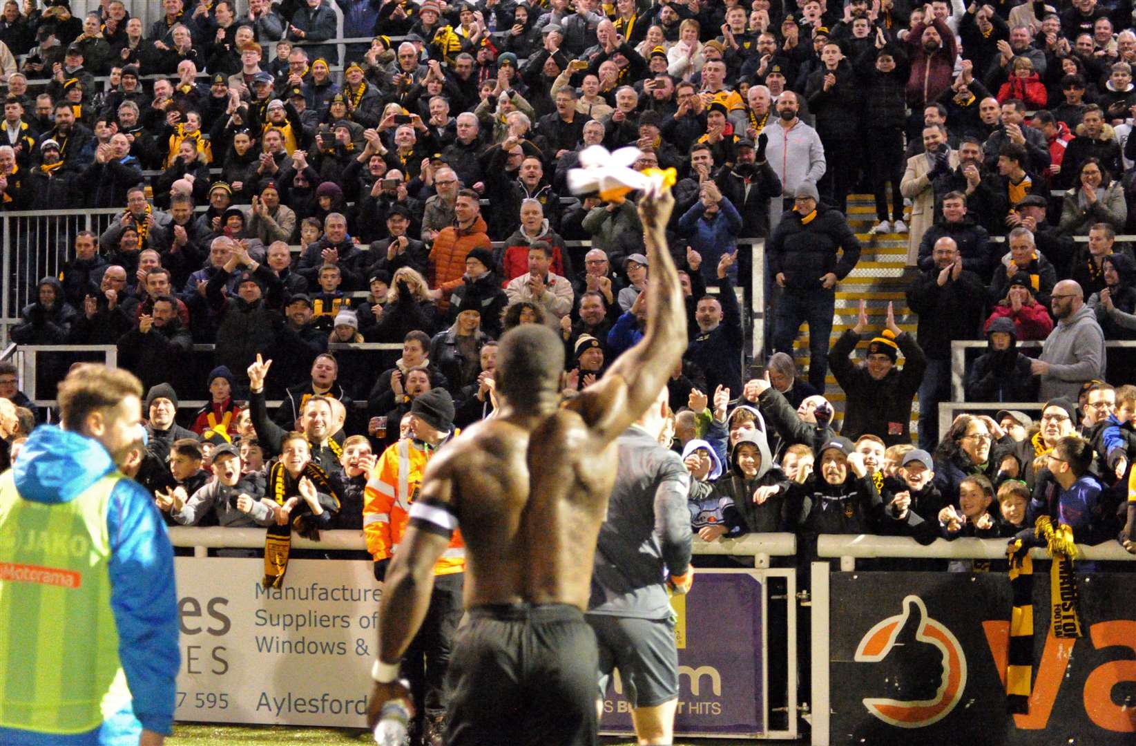 Maidstone captain George Elokobi leads the celebrations in front of the Genco Stand Picture: Steve Terrell