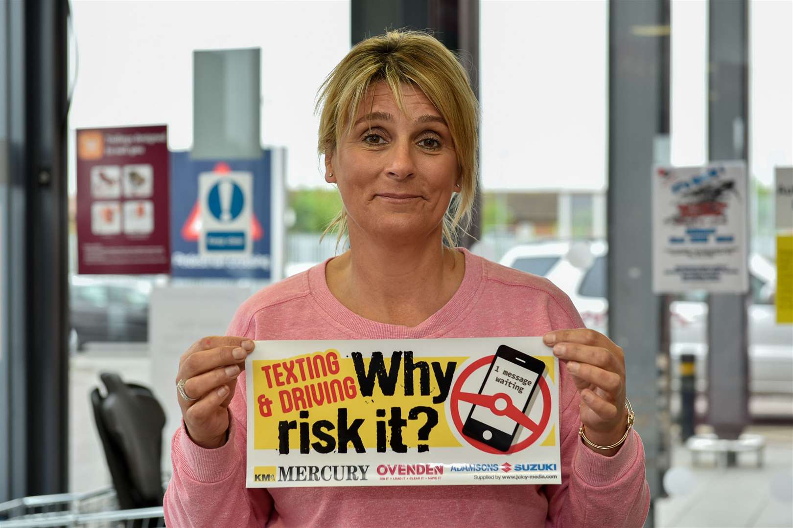Tracy Squire with a Why Risk It? sticker highlighting the dangers of texting while driving