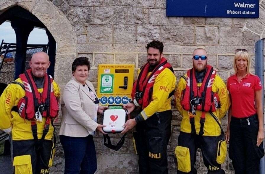 Parish council chairman Cllr Sue Le Chevalier and Beverley-Jane Last joined lifeboat volunteers to unveil the defibrillator