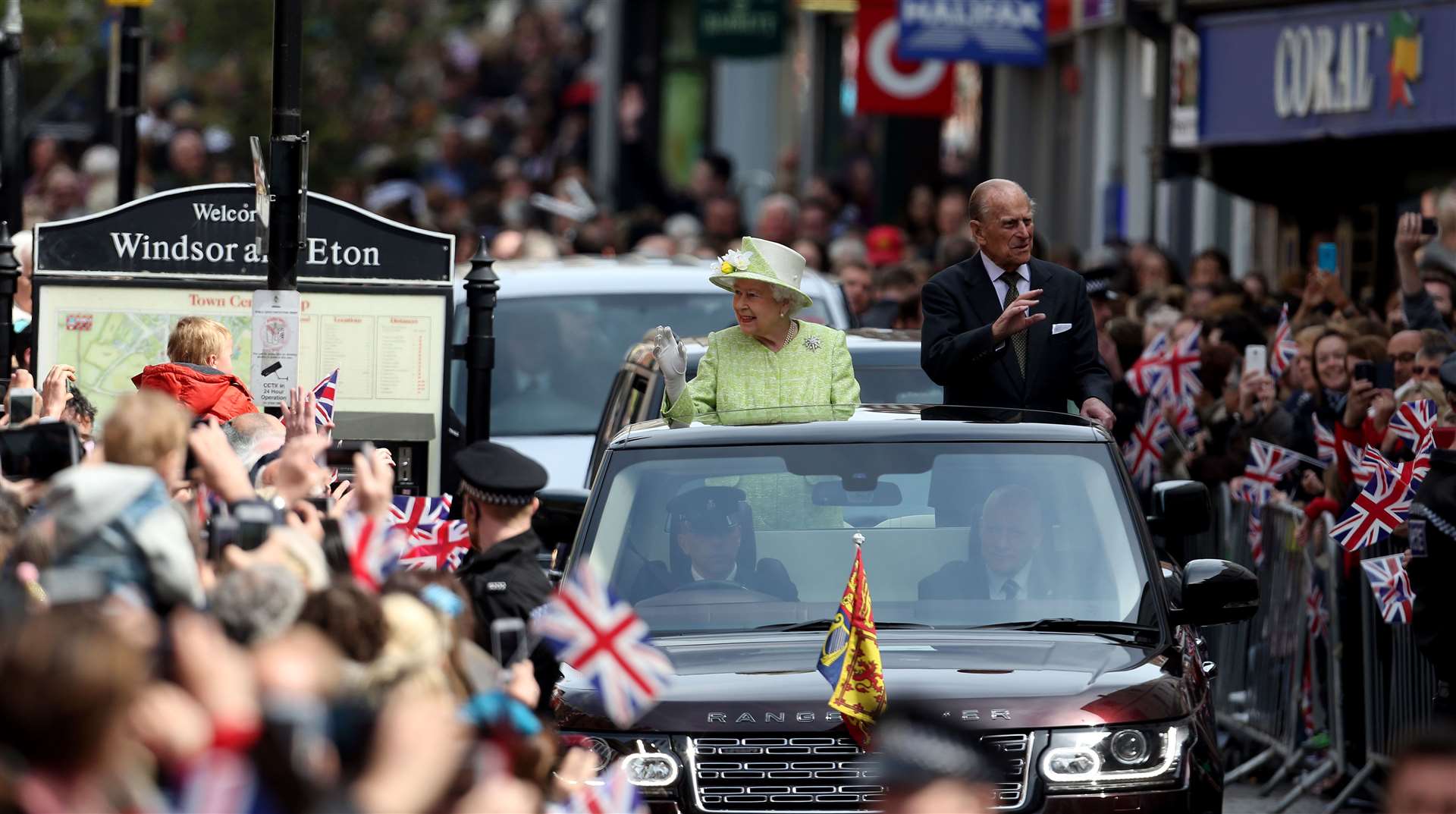 The Queen and Philip ride in an open-top Range Rover in Windsor to mark the monarch’s 90th birthday (Steve Parsons/PA)