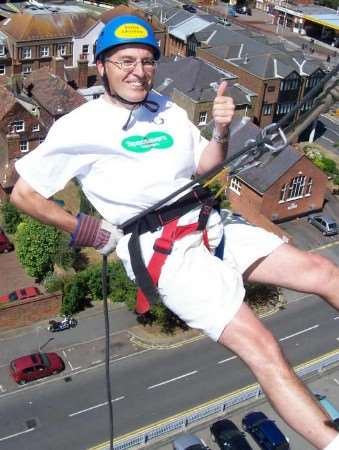 Clive Perry of Specsavers abseils down Charter House, Ashford.