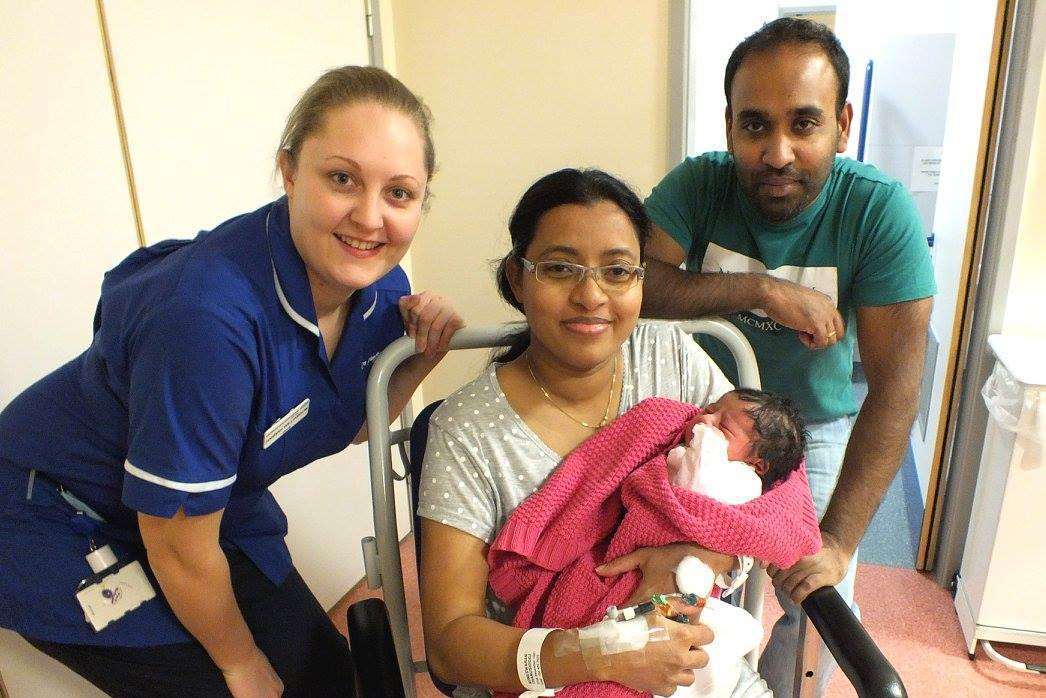 Baby Koneswaran born on Christmas Day, with mother Thanushigga and partner Sundaralingam, all from Dartford, with midwife Hannah Williamson