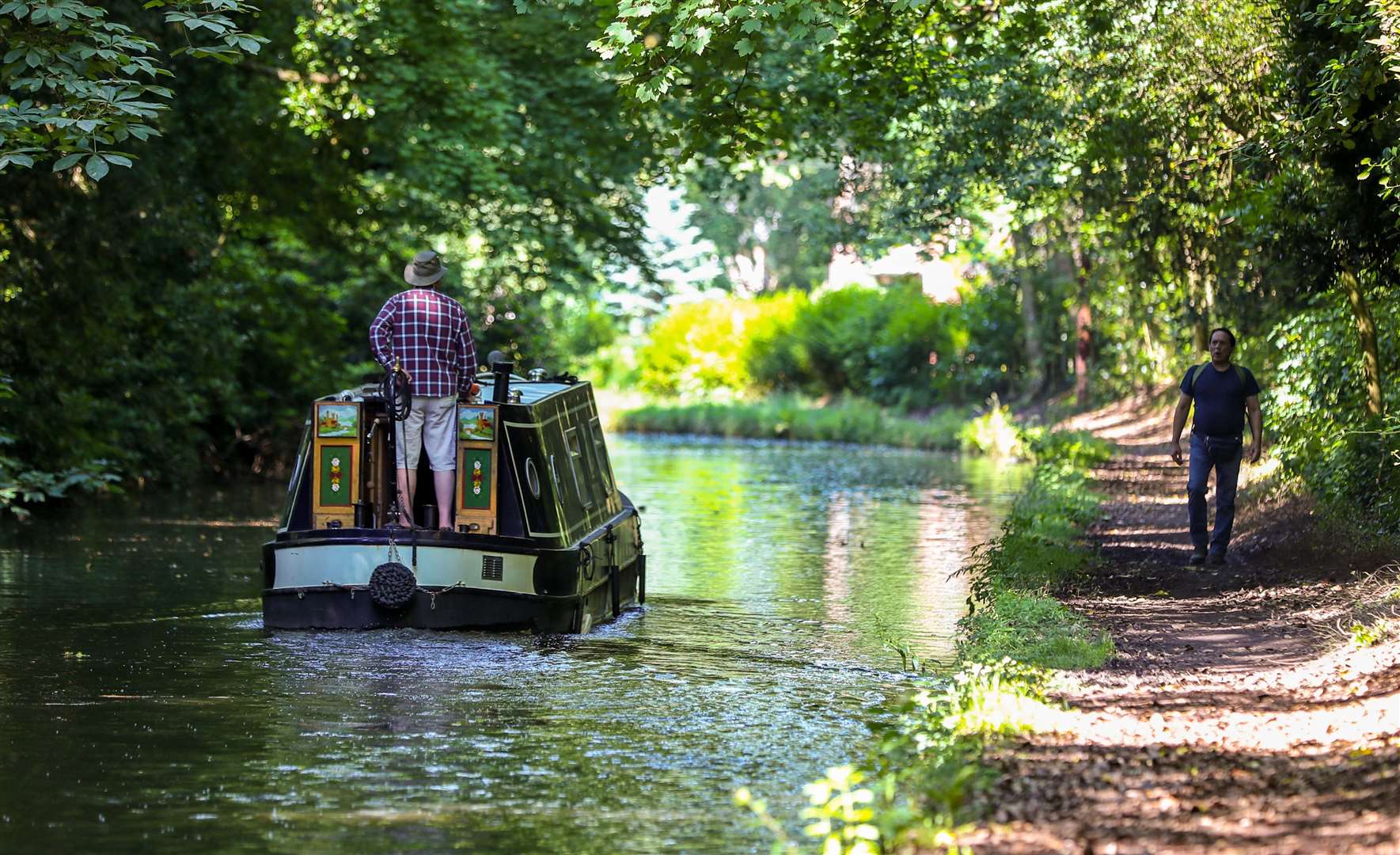 Things were rather more sedate in Cheshire, as a boat meandered along the Bridgewater Canal in Walton Hall (Peter Byrne/PA)