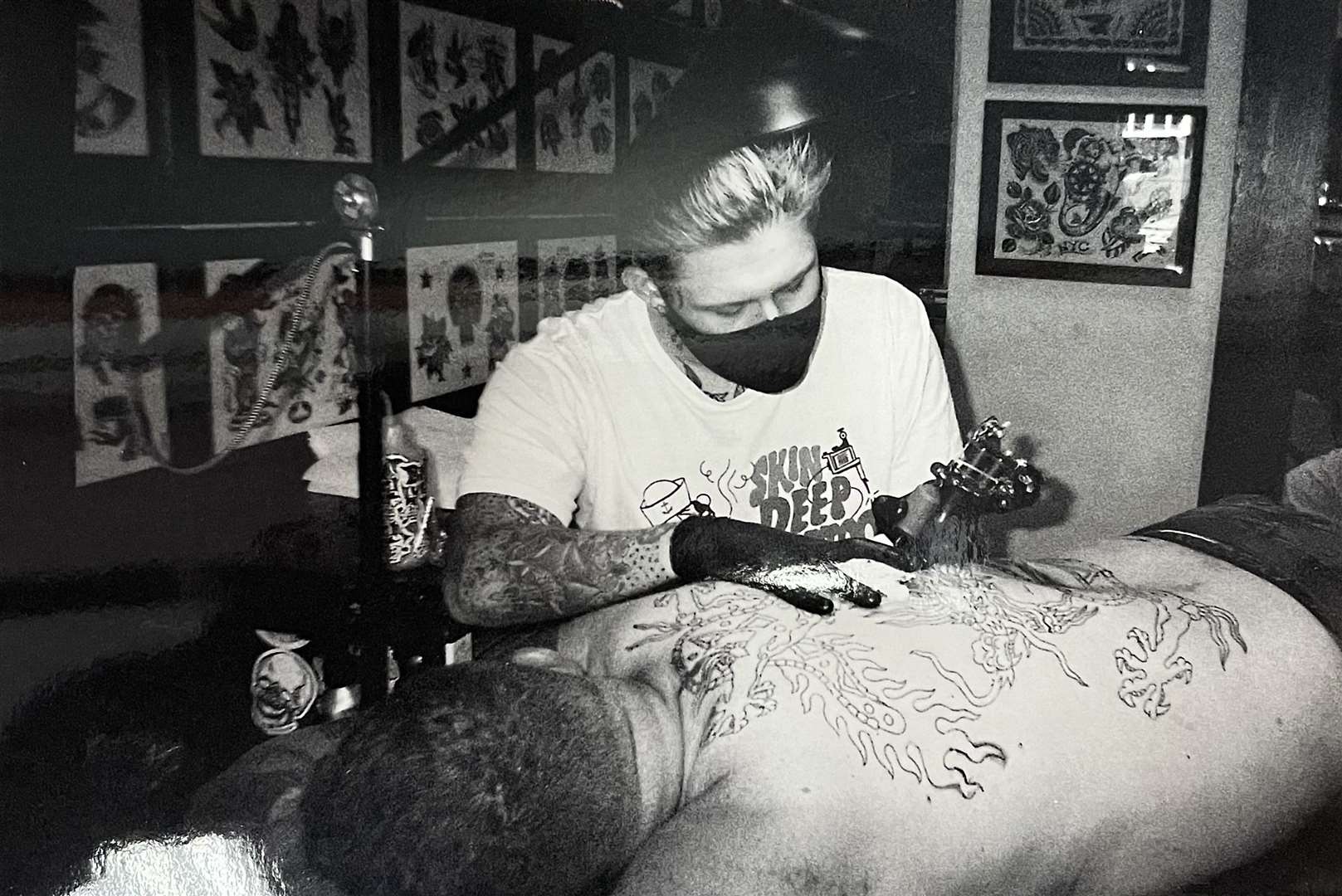 Finn Guthrie at work in his tattoo parlour