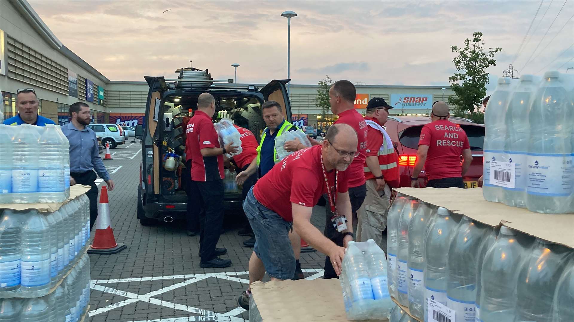 Kent's Search and Rescue volunteers loading water bottles into cars and vans at Neats Court retail park, Queenborough