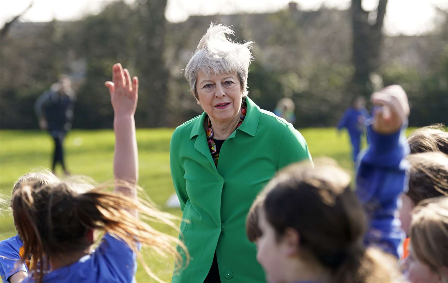 Former prime minister Theresa May talks to schoolgirls at a football session during a visit to St Mary’s Catholic Primary School in Maidenhead, Berkshire (Andrew Matthews/PA)