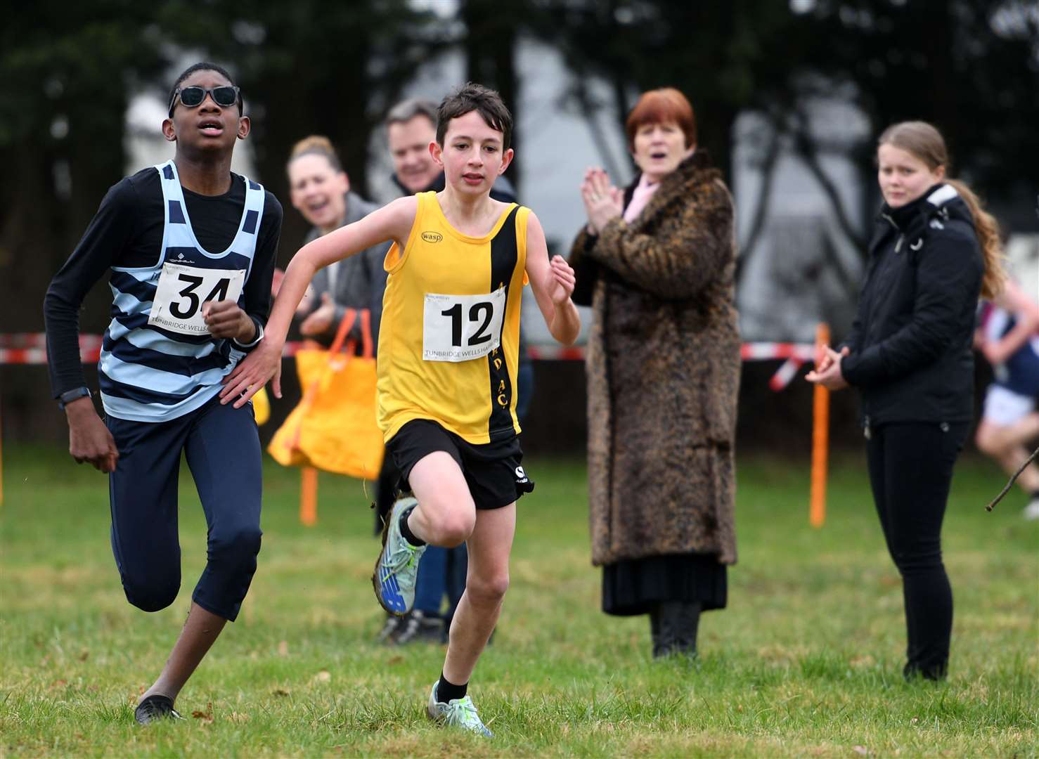 James Wilcox (No.12) of Ashford & Weald holds back Gideon Wade of Canterbury & St Augustines in the Year 7 boys' race. Picture: Barry Goodwin (54437742)