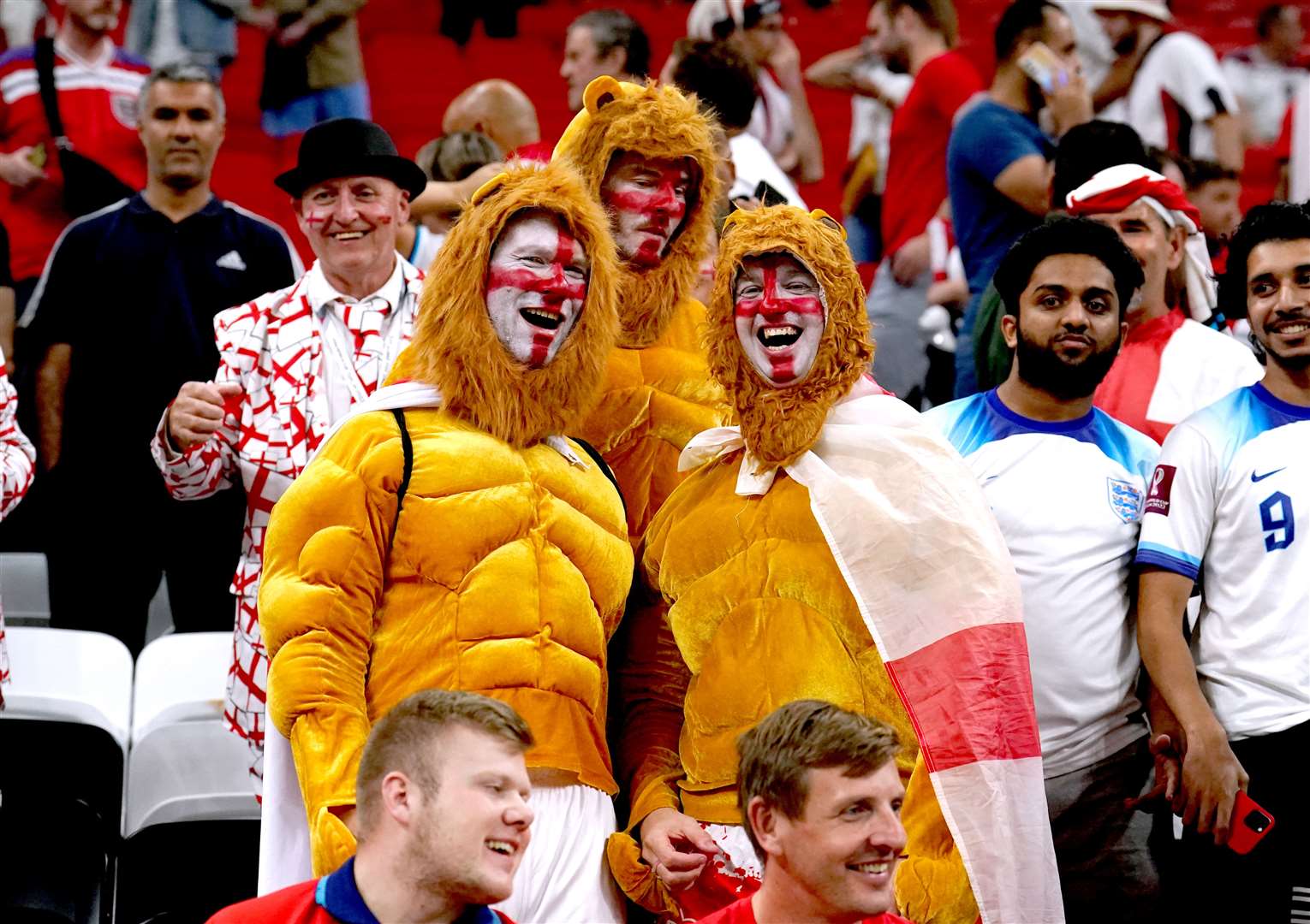 England fans dressed as three lions in the stands in Qatar (Martin Rickett/PA)