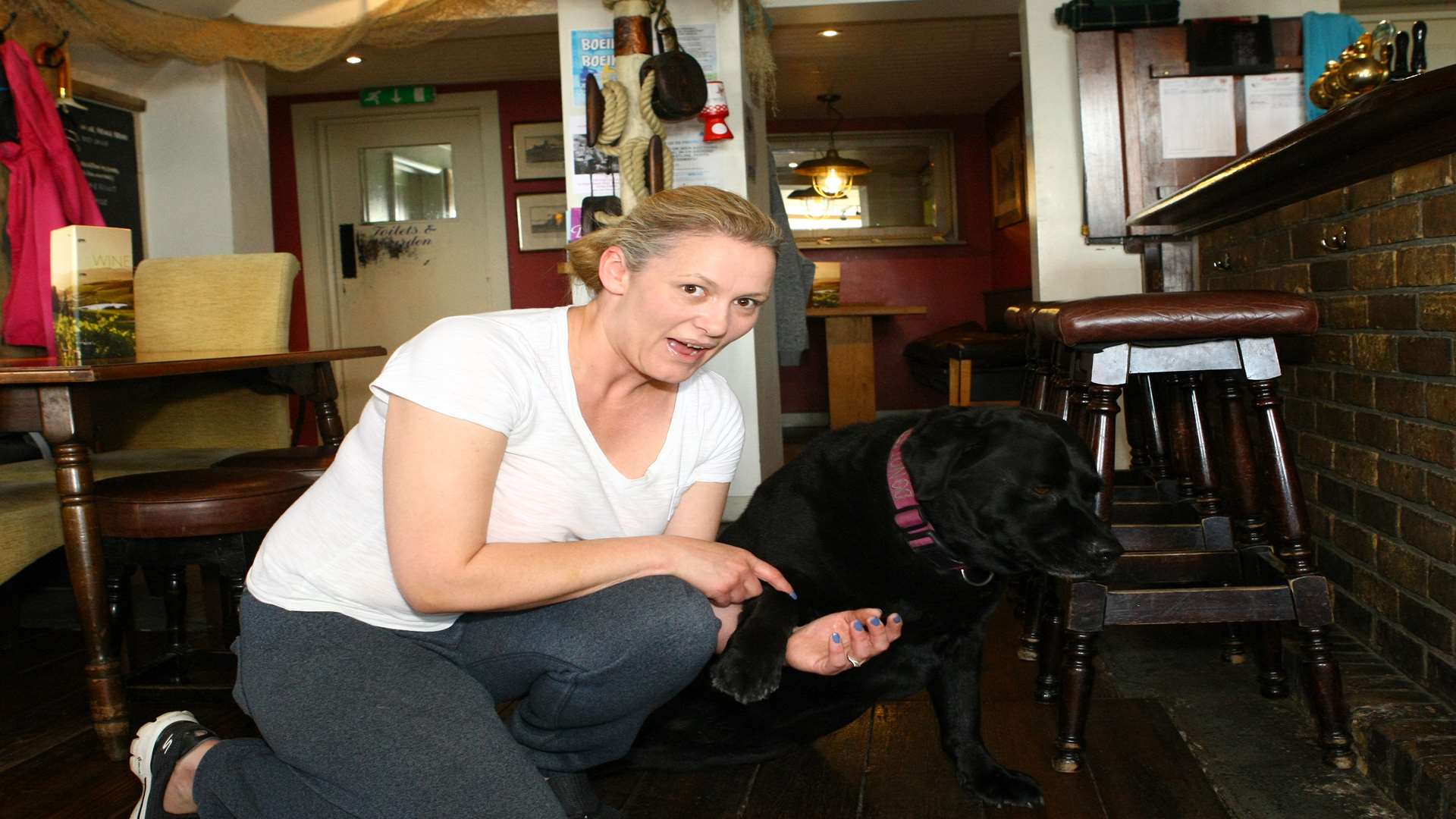 Port Arms landlady Kerensa Miller and the pub's resident dog Bruno