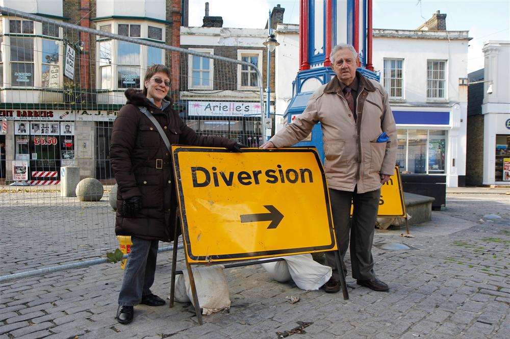Cllr Steve Worrall and Cllr Angela Harrison in Sheerness High Street - where repair work has finally started