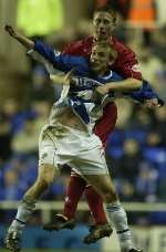 Luke Chadwick battles with former Gills defender Roland Edge in his reading days
