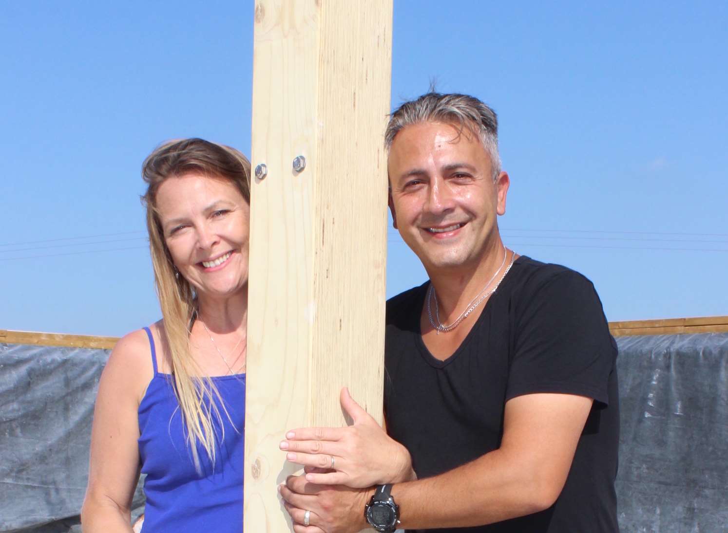 Heidi and Sav Pavlou work together to erect one of the first wooden timber posts