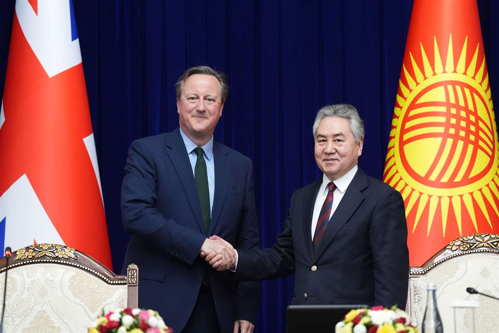 Foreign Secretary Lord David Cameron shakes hands with the minister of foreign affairs of the Kyrgyz Republic Jeenbek Kulubaev (Stefan Rousseau/PA)