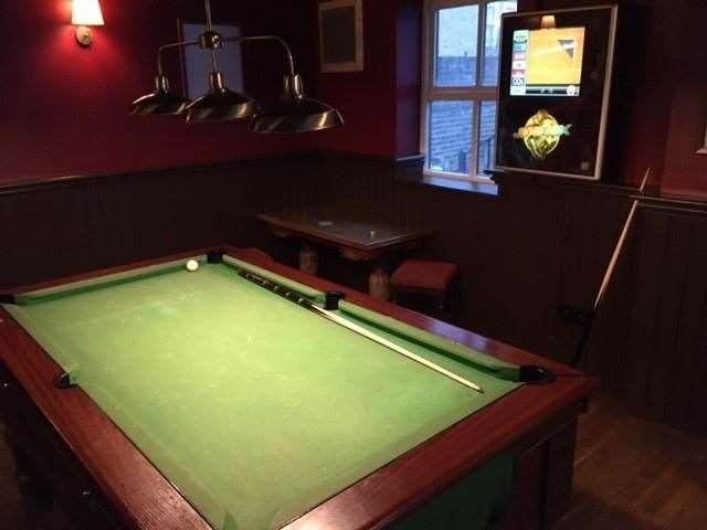 There is a pool table right at the back of The George just in front of the jukebox and the toilets.
