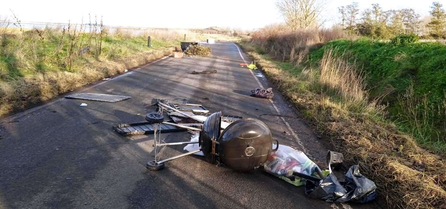 A BBQ grill, plastic box lids and other household waste were dumped in Raspberry Hill Lane, near Iwade. Picture: Anna Vaughan