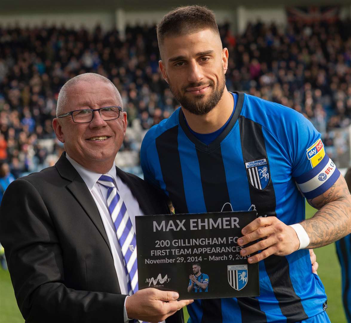 Gillingham chairman Paul Scally presents a plaque to Max Ehmer on his 200th game for the club Picture: Ady Kerry