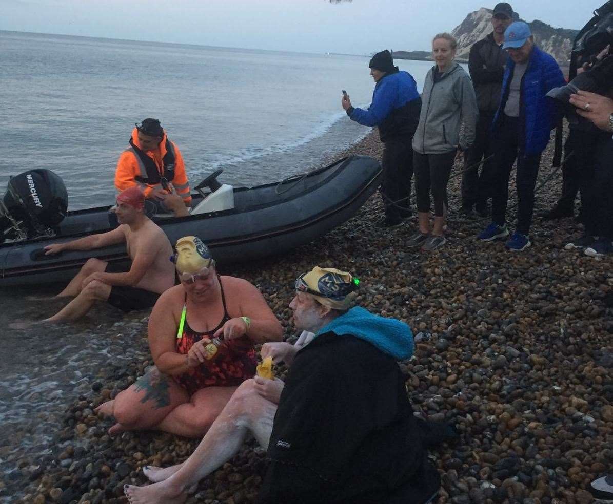 Sarah Thomas, at the forground, after her swim to Dover today. Picture: Emily Craft