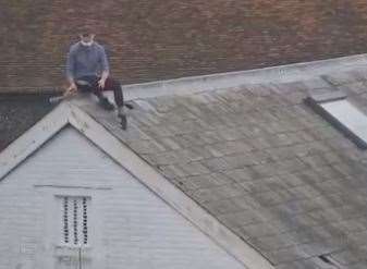 Trespasser on the roof of the former Nasons store in Canterbury city centre