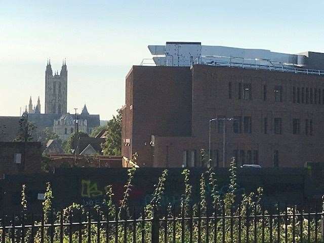 The air conditioning units atop a building at CCU, with Canterbury Cathedral in the background
