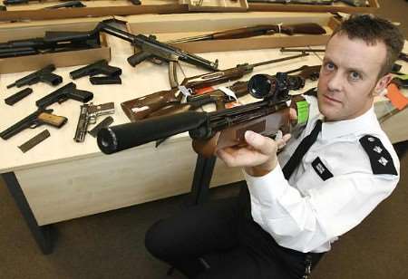 Inspector Andy Johnstone with an air rifle. Picture: JAMIE GRAY
