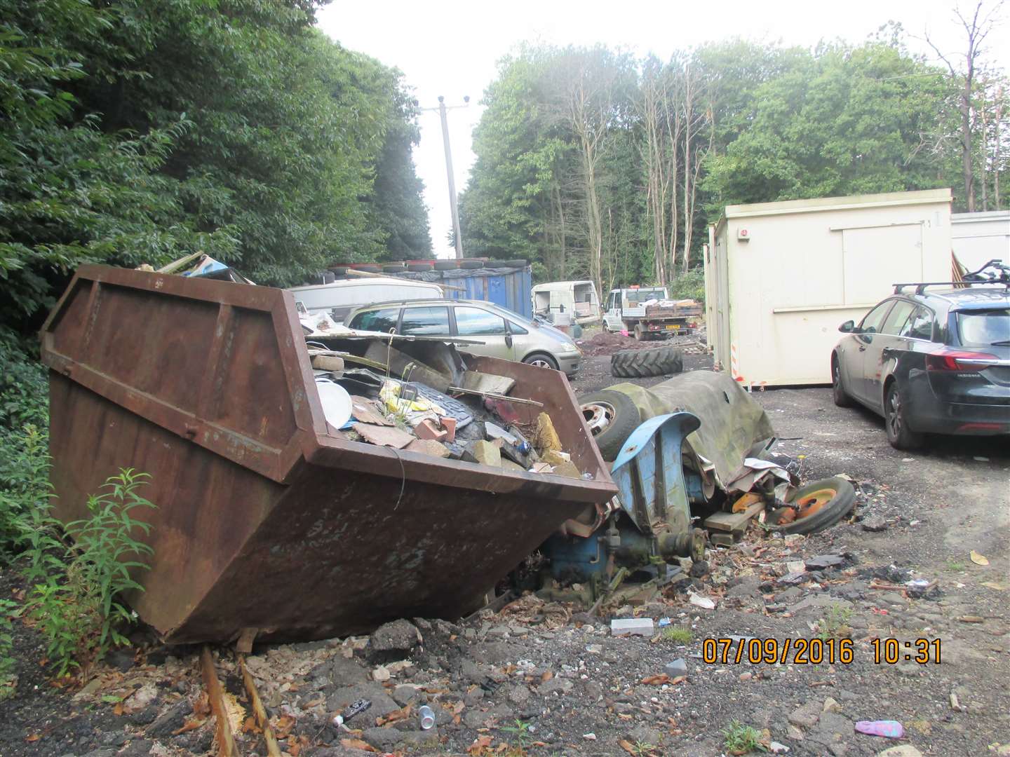 A skip full of rubbish alongside tractor tyres in the middle of Boxley Wood on land owned by Langley Beck in 2016. Picture: Maidstone Borough Council