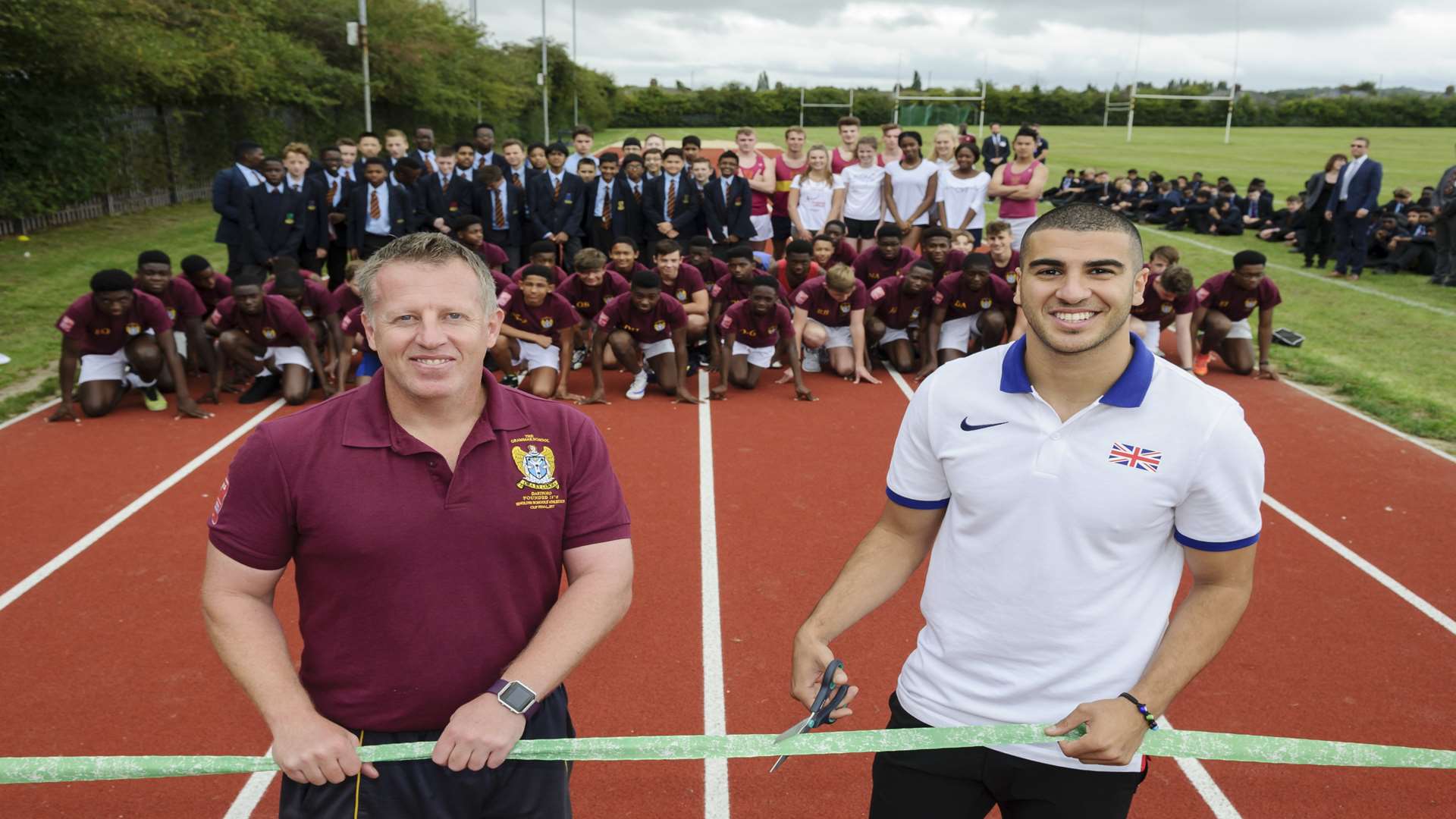 Adam Gemili, right with his old teacher Gary Jones, head of Sport and Games, cutting the ribbon on the new track