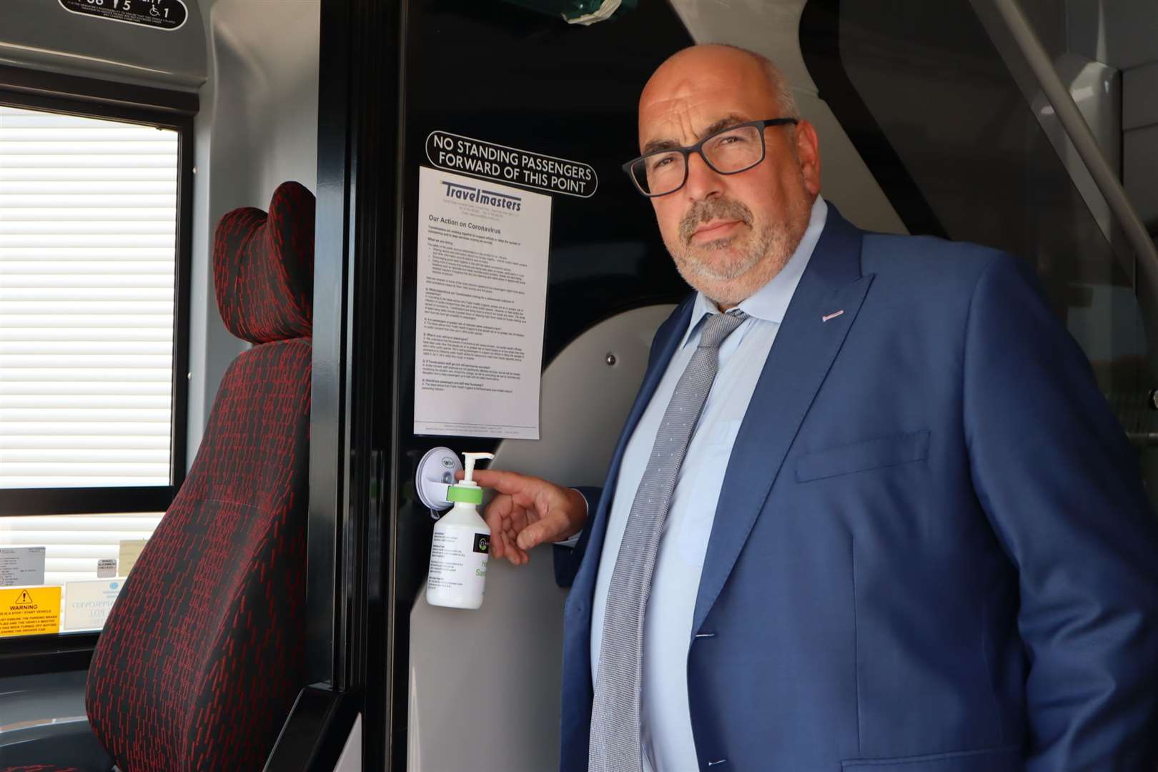 Tim Lambkin of Sheerness coach firm TravelMasters points out the hand sanitiser on his buses