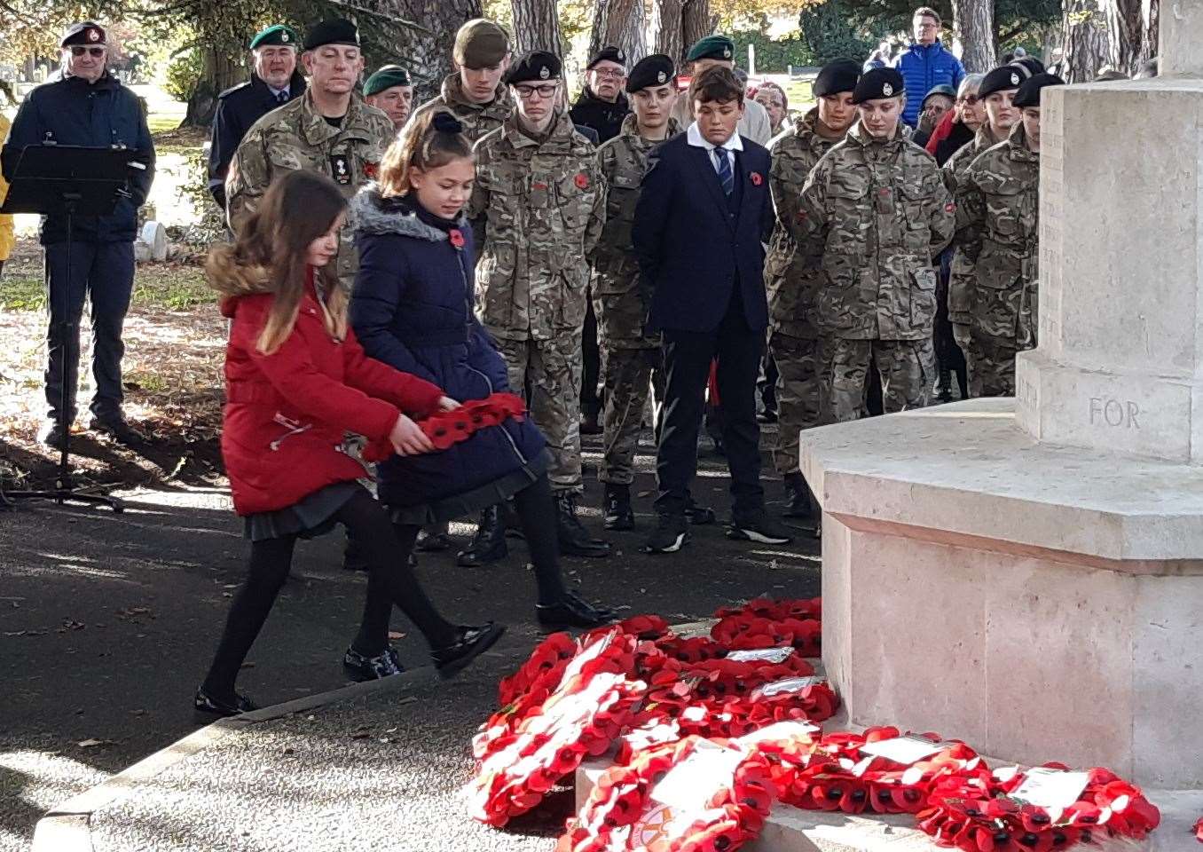 Schoolchildren honouring the war dead with wreaths