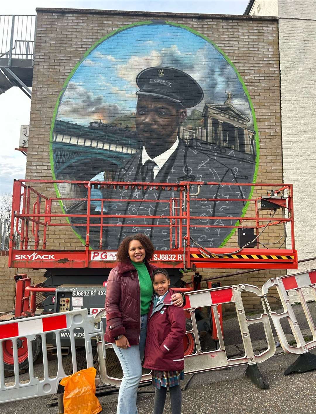 Camealia and her daughter in front of the mural of her grandfather in Chatham. Picture courtesy of Arches Local