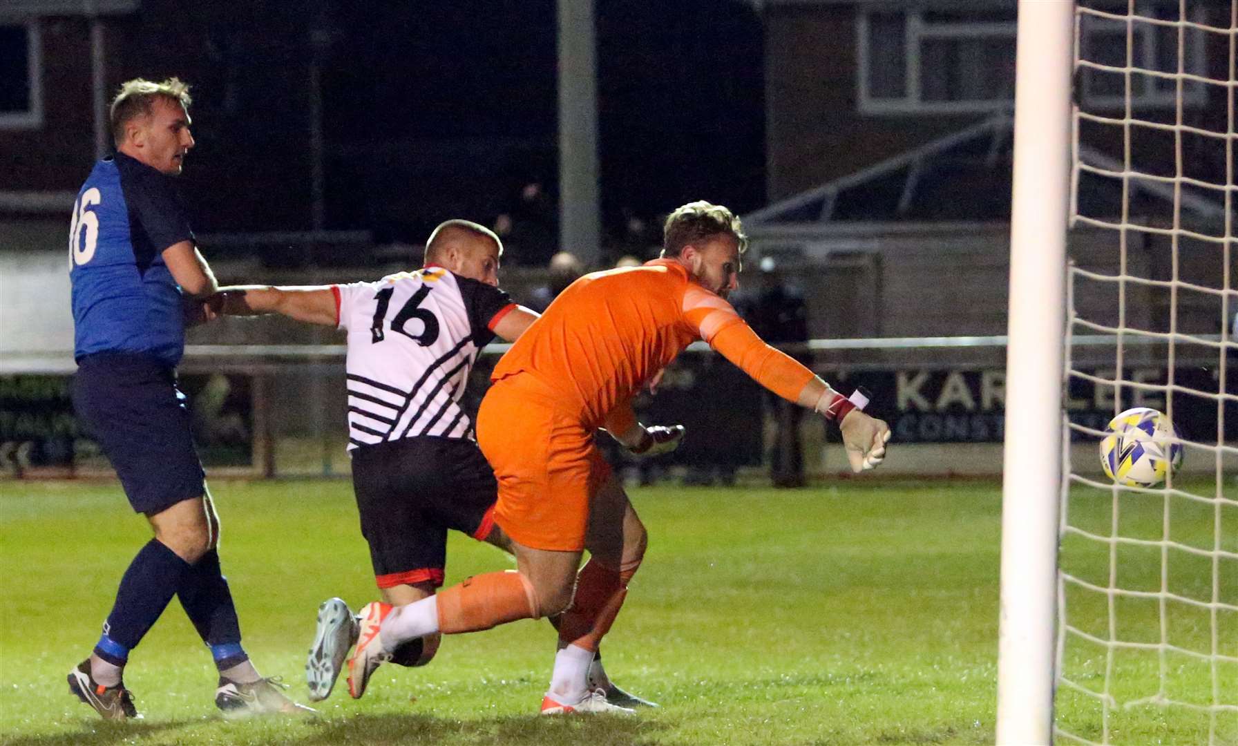 Two-goal Kaeden Jefferys gets the ball past Faversham Strike Force goalkeeper Harry Earls to score on his first-team Deal Town debut. Picture: Paul Willmott