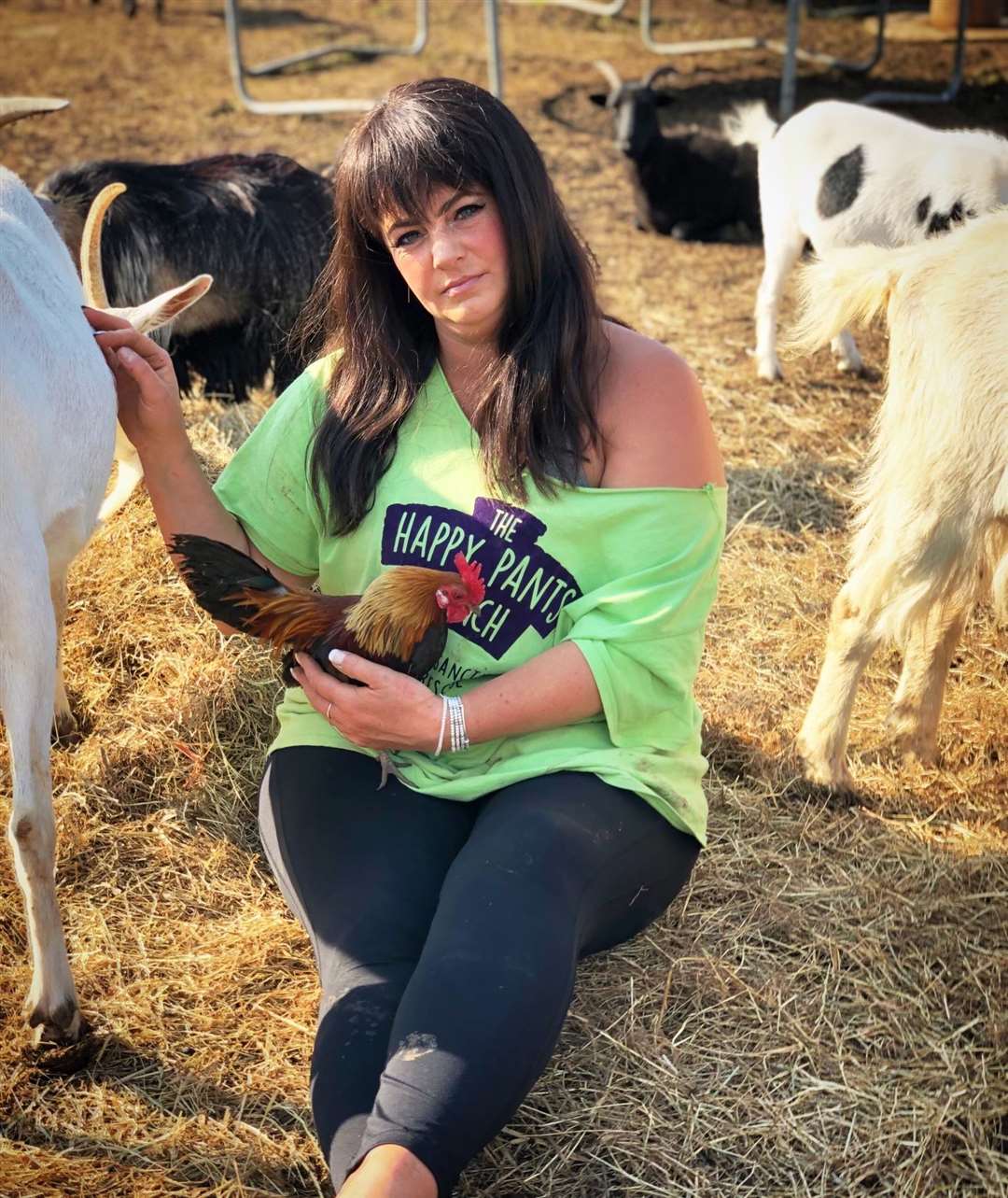 Amey James, founder of The Happy Pants Ranch at Bobbing with cockerel and goat