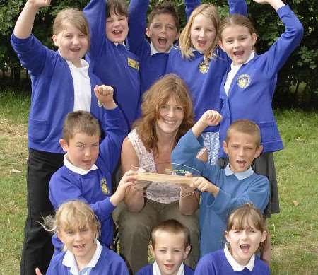 GREAT TO BE GREEN: deputy head Dr Paula Owens and pupils with the trophy. Picture: ANDY PAYTON