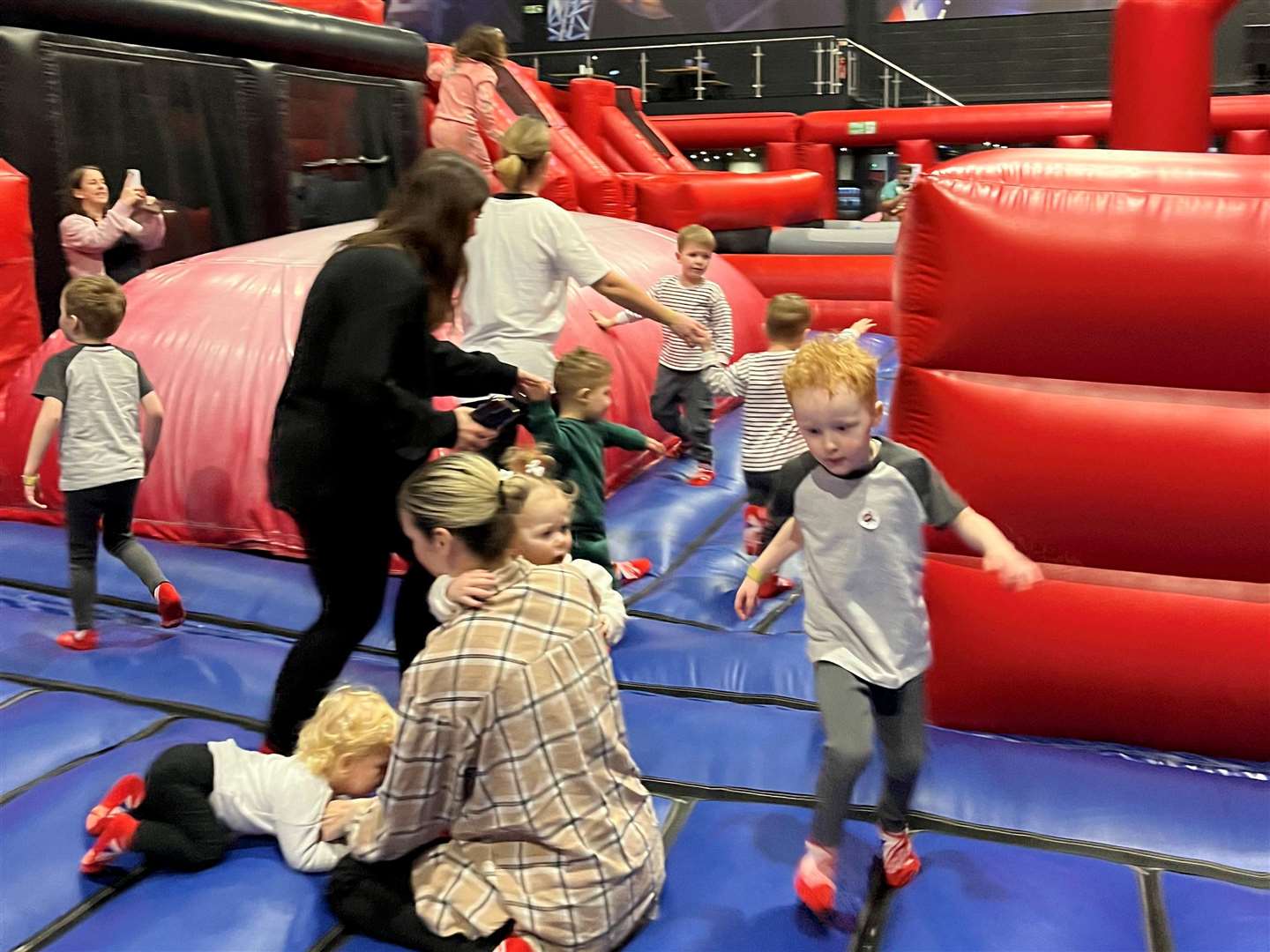 Toddlers enjoying the giant inflatable for the first time at Ninja Warrior UK Adventure Park in Chatham