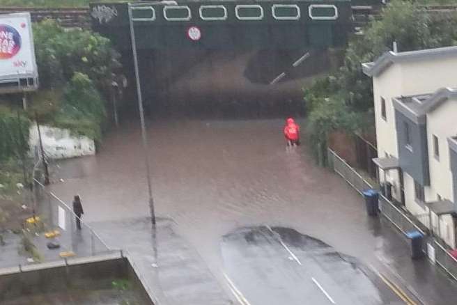 The postman wades through the flood in All Saints Avenue, Margate. Picture: Dan Thompson