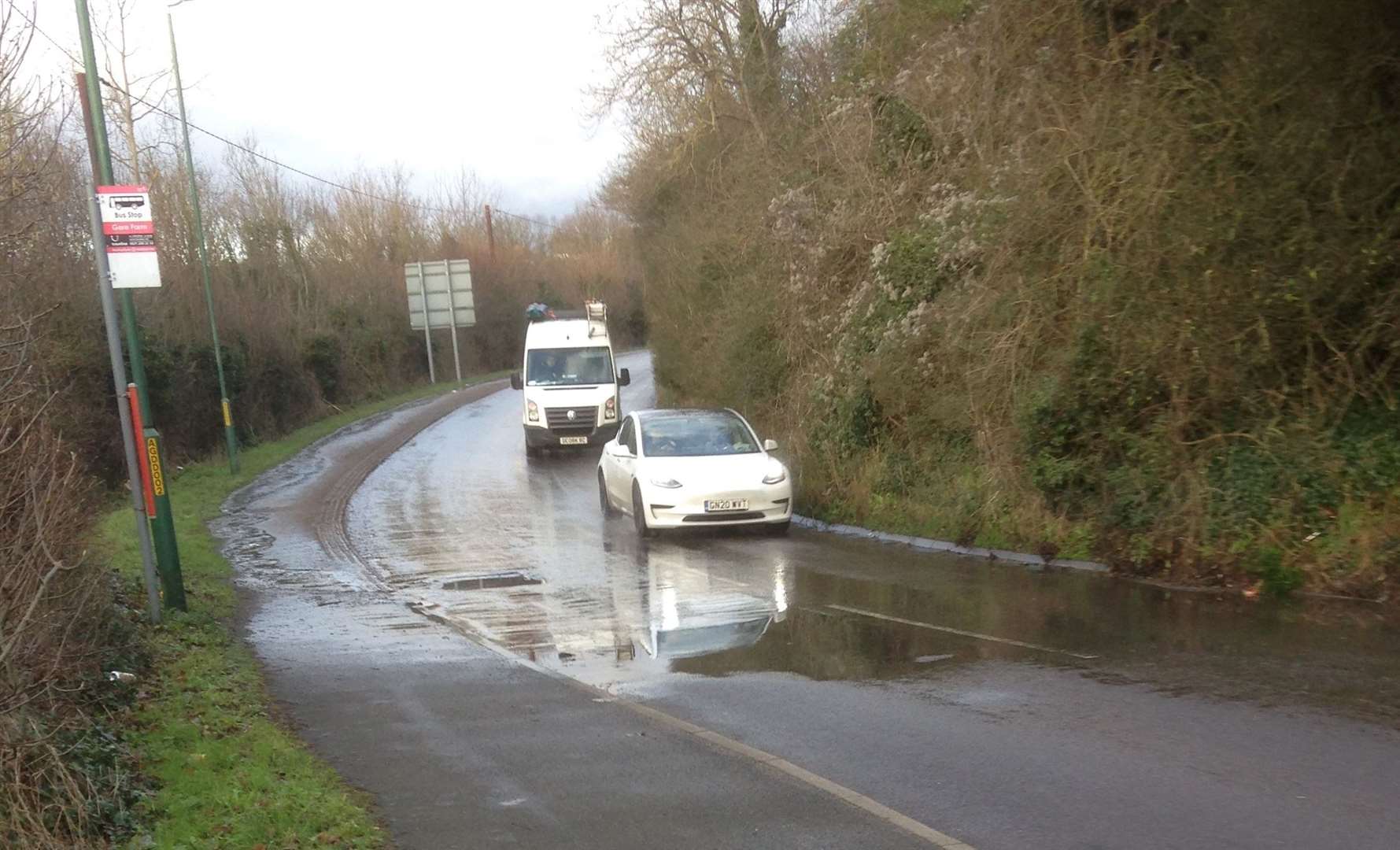The water has created puddles at the bottom of the road