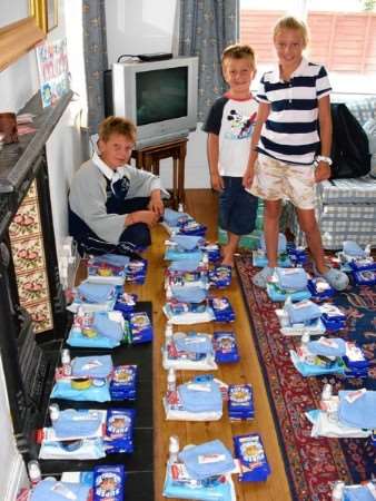 Round Tabler Digby Williams' three children, left to right, Alexander, Ben and Katie, packed the airlift parcels for Canterbury troops serving in Afghanistan