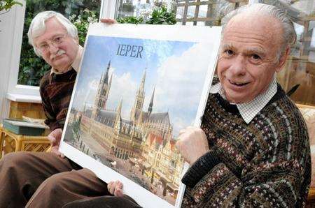 Graham Greene, left, and Malcolm Moore, secretary and chairman of the Sittingbourne and Milton Twinning Association, with one of the pictures the association has acquired from twin town Ypres
