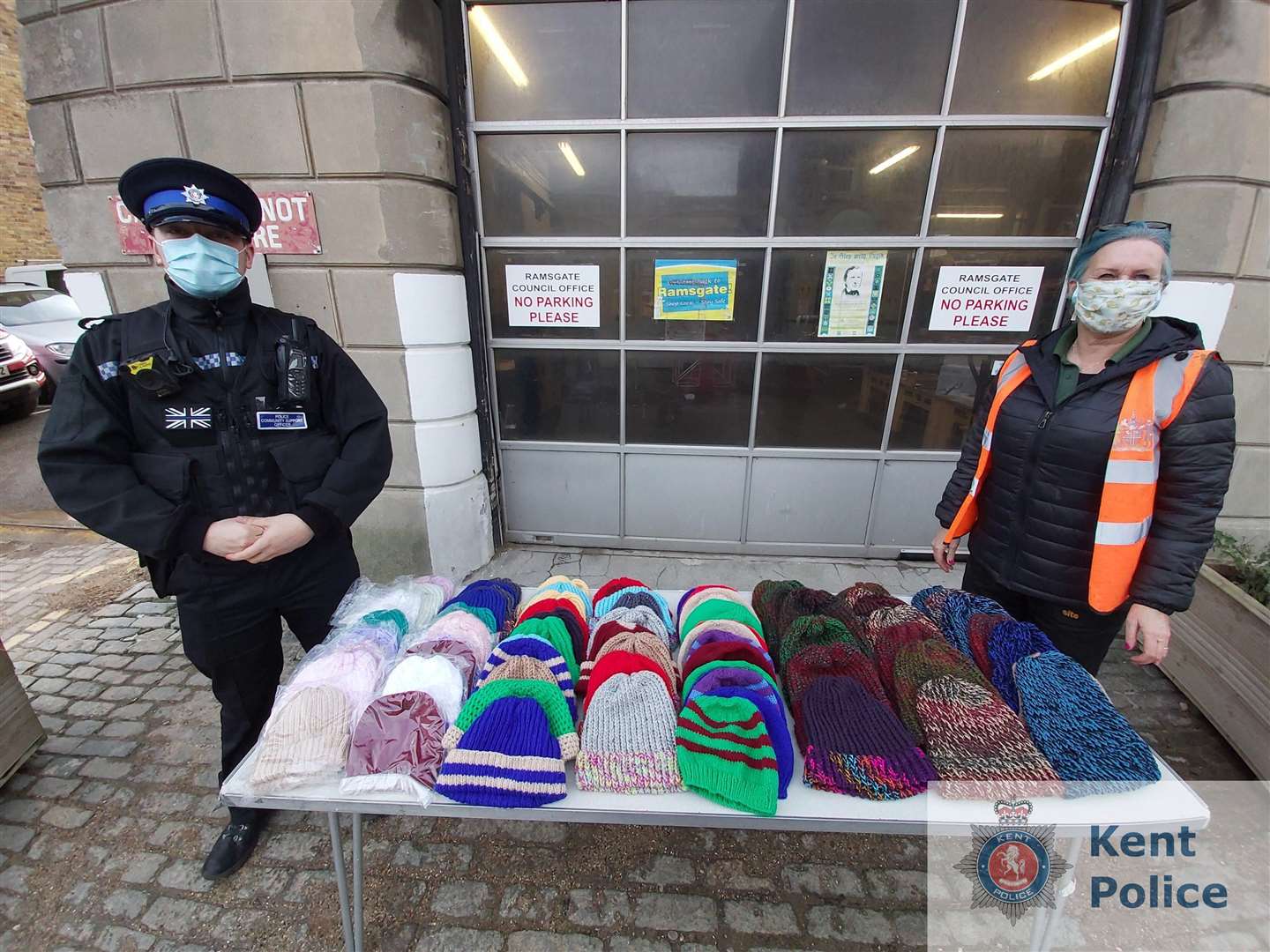 PCSO Brandon Greenleaf with Ramsgate Town Council's Maxine Morgan with the knitted hats. Picture: Kent Police