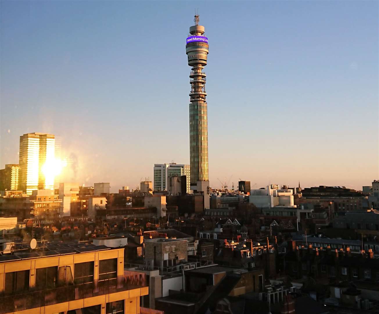 The sunrise reflects off Euston Tower as the BT Tower said "Good Morning London" on Sunday - the view from our room at Treehouse London