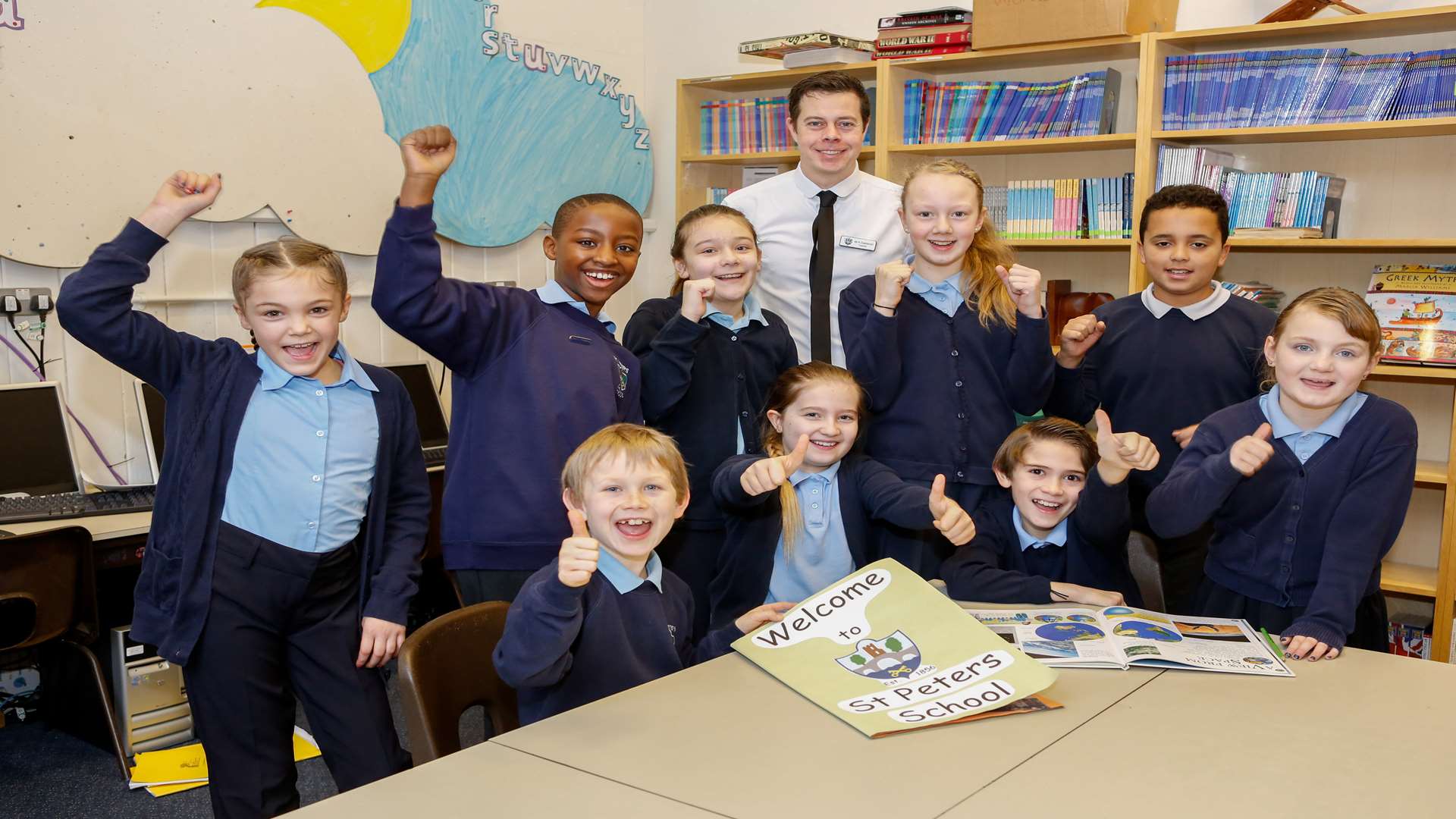 Year 6 teacher Kieron Eastwood with pupils from year's 4, 5 and 6 celebrating a good Ofsted report.