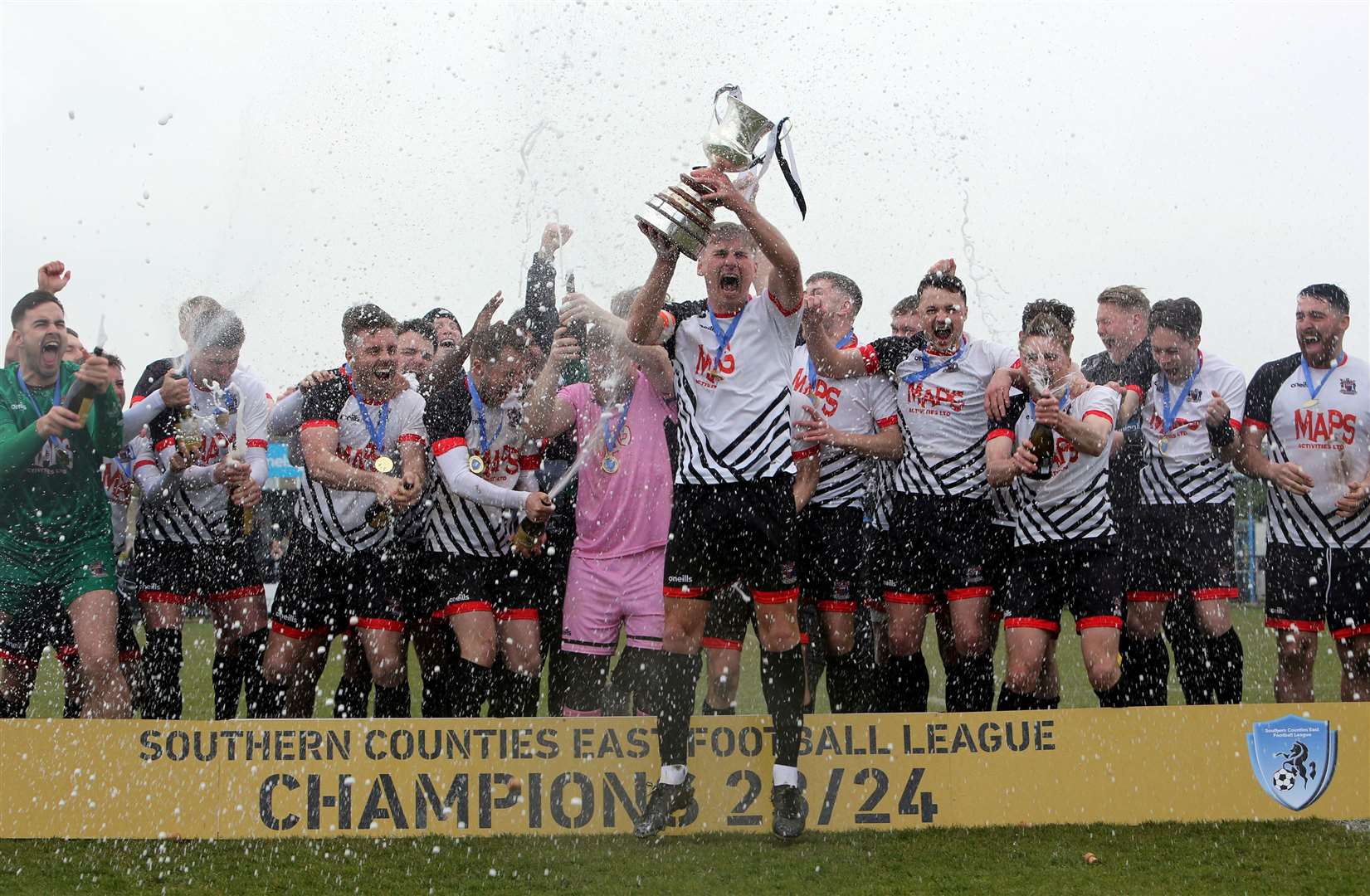 Deal club captain Kane Smith lifts the trophy for the champions. Picture: Paul Willmott