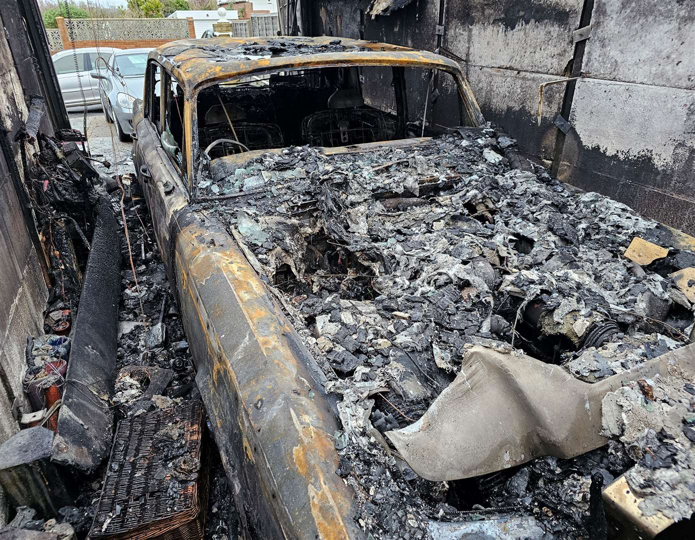 The damage the fire caused to Emma Churchill's dad's classic car and garage. Picture: Emma Churchill