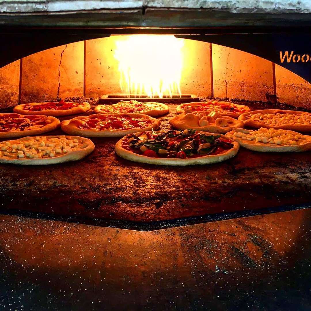 The pizzas are cooked for three minutes at 400 degrees