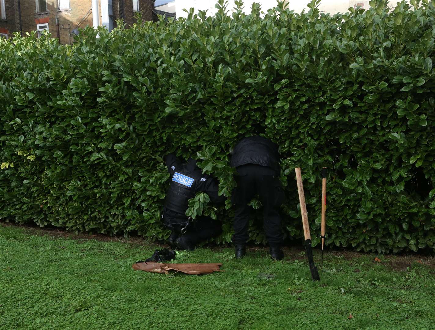 Police scour bushes around Fox Street, Gillingham. Picture: UKnip. (24844633)