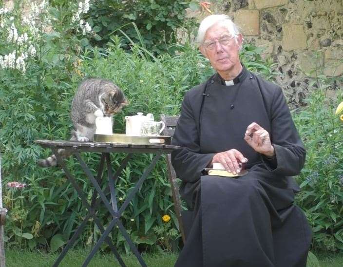 Tiger the cat steals Dean of Canterbury's milk during morning prayers in July 2020. Picture: Canterbury Cathedral / YouTube