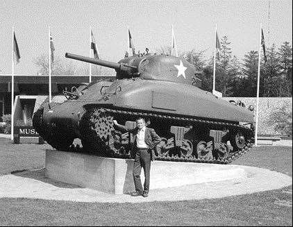 Ernest Slarks stood next to a Sherman tank