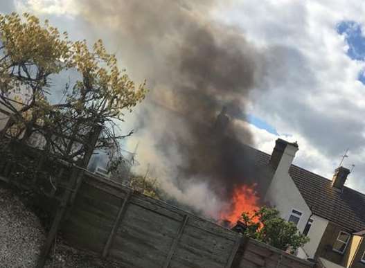Flames coming from the shed. Picture: Una Seale