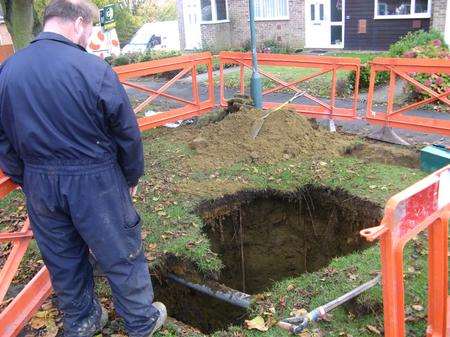 An engineer at stands by the 30-foot deep hole in Maidstone