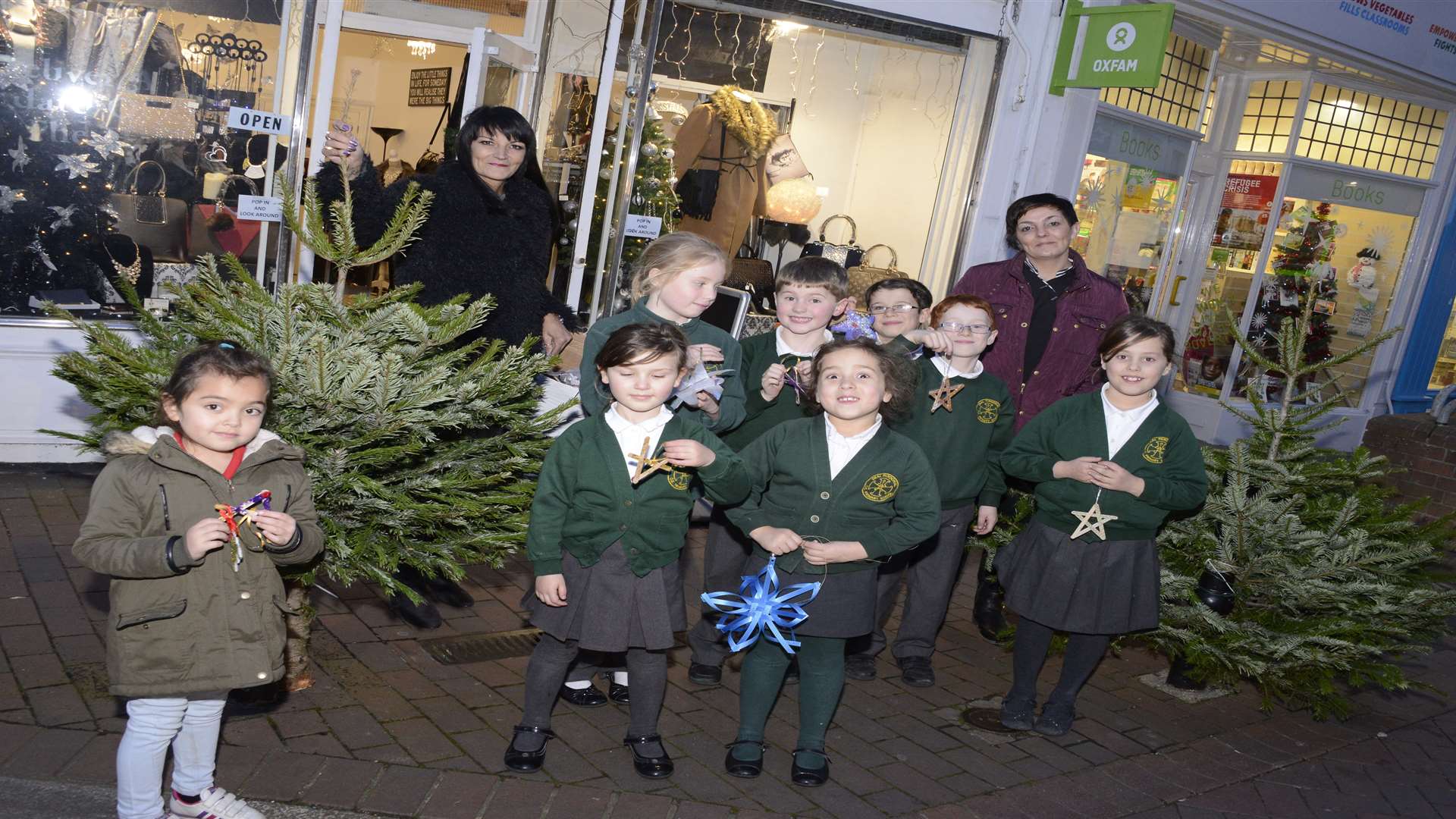 Diva Boutique owner Amanda Goring and Hair stylist Tanya Freney with youngsters from Deal Parochial school. They decorated the Christmas trees outside the shop with decorations they made